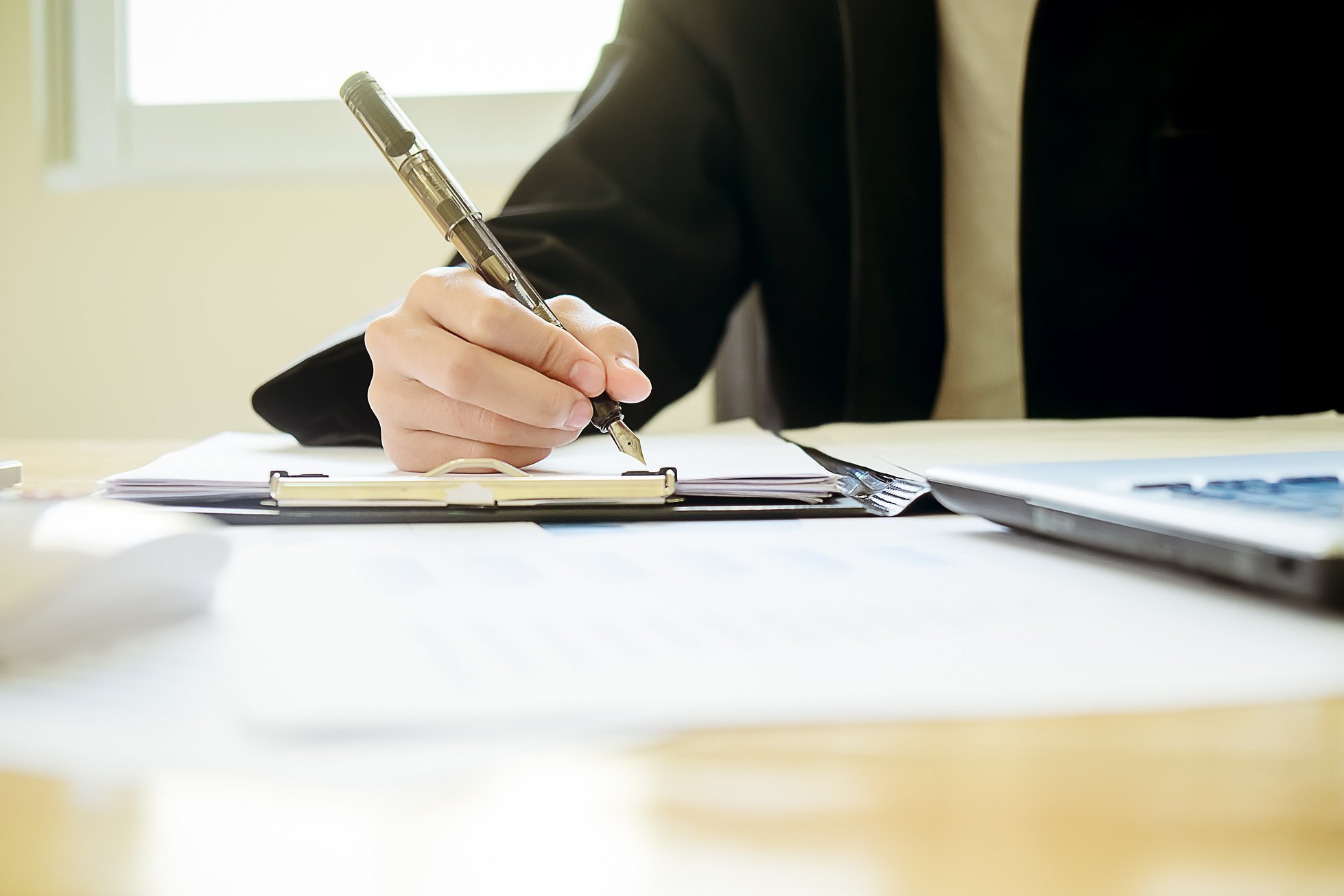 Close-up of Businessperson Signing Contract